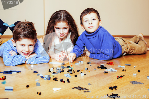 Image of funny cute children playing lego at home, boys and girl smiling, first education role lifestyle