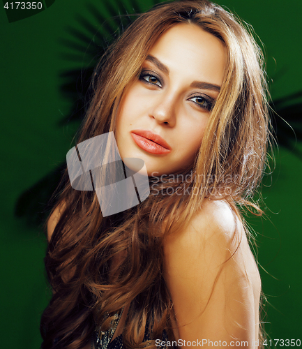 Image of young cute blonde woman on green palm background smiling happy, lifestyle peole concept