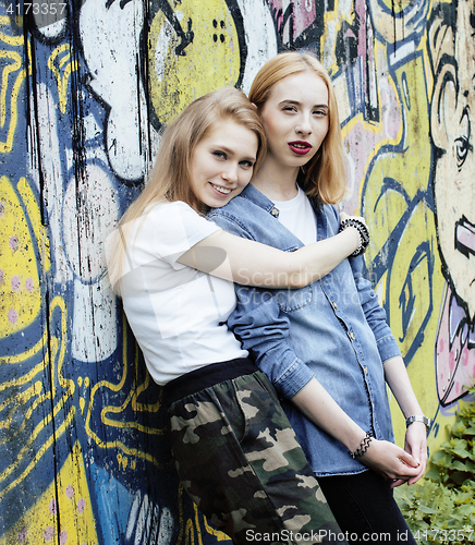 Image of Two teenage girls infront of university building smiling, having fun traveling europe, lifestyle people concept 