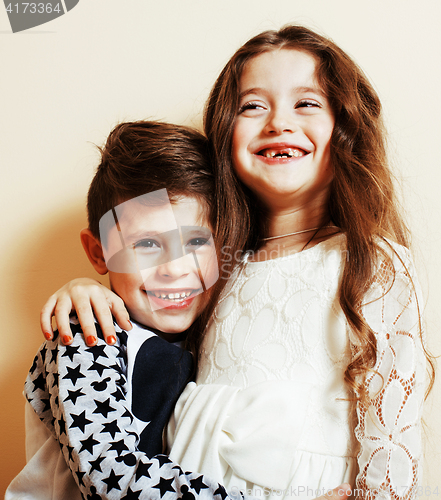 Image of little cute boy and girl hugging playing on white background, ha