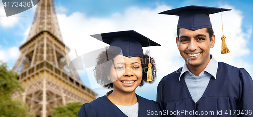 Image of happy students or bachelors over eiffel tower