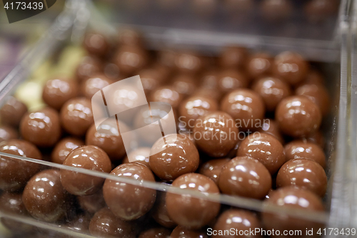 Image of close up of chocolate dragee candies in box