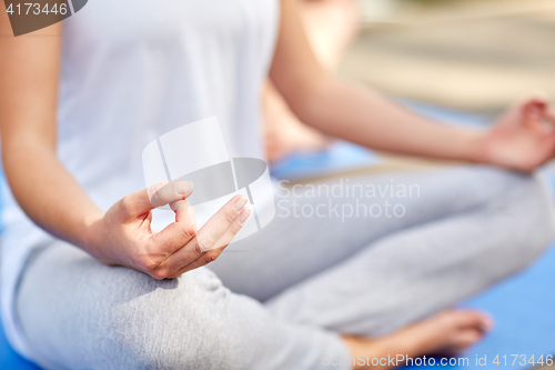 Image of close up of woman meditating in easy sitting pose