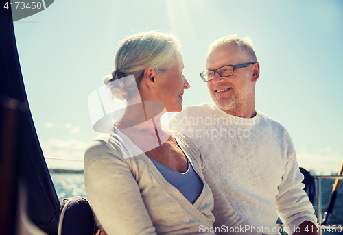 Image of senior couple hugging on sail boat or yacht in sea