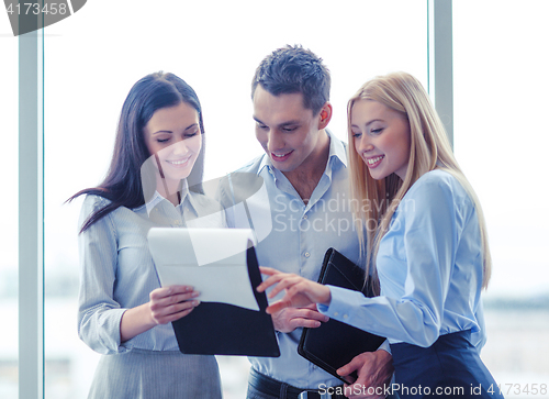 Image of business team looking at clipboard