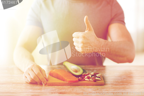 Image of close up of male hands with food rich in protein