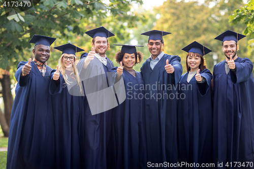 Image of happy students or bachelors showing thumbs up
