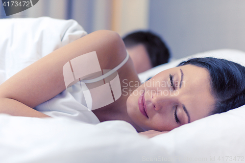 Image of happy couple sleeping in bed