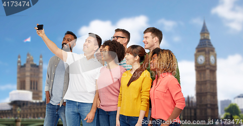 Image of group of people taking selfie by smartphone