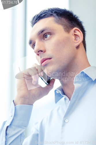 Image of serious businessman with smartphone