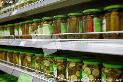 Image of jars of pickles on grocery or supermarket shelves