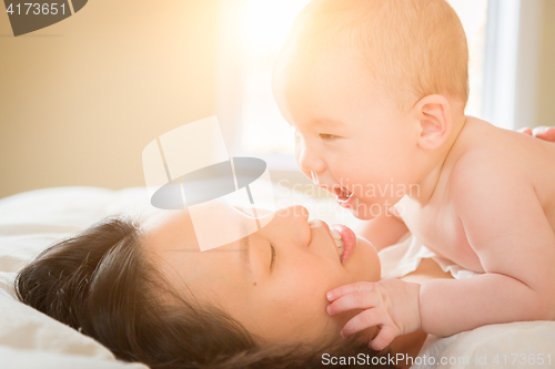 Image of Mixed Race Chinese and Caucasian Baby Boy Laying In Bed with His