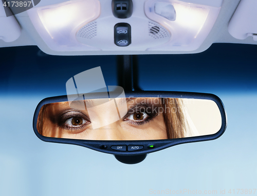 Image of driver looks to rear view mirror