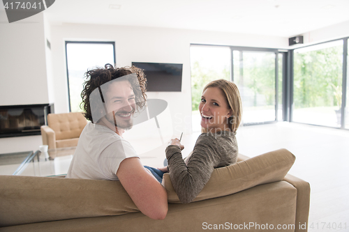 Image of Rear view of couple watching television