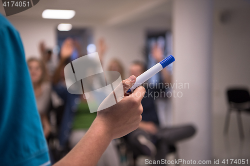 Image of close up of teacher hand with marker