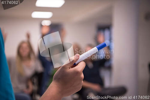 Image of close up of teacher hand with marker