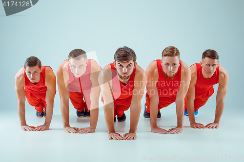 Image of The group of gymnastic acrobatic caucasian men on balance pose