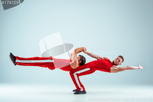 Image of The two gymnastic acrobatic caucasian men on balance pose