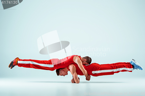 Image of The two gymnastic acrobatic caucasian men on balance pose