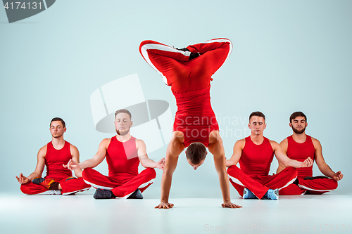 Image of The group of gymnastic acrobatic caucasian men on balance pose