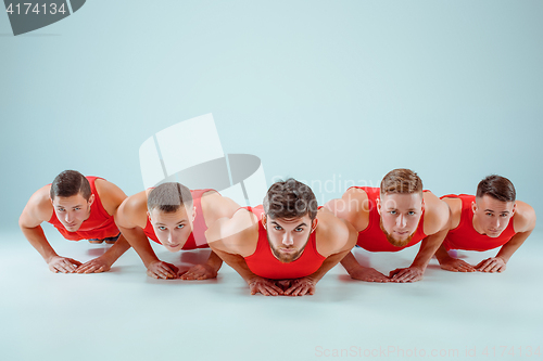 Image of The group of gymnastic acrobatic caucasian men on balance pose