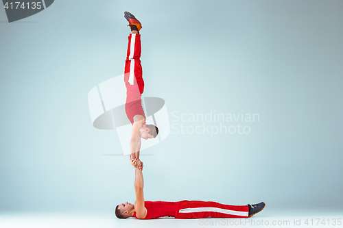 Image of The two gymnastic acrobatic caucasian men on balance pose