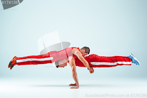 Image of The two gymnastic acrobatic caucasian men on balance pose