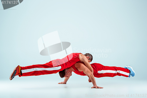 Image of The two gymnastic acrobatic caucasian men on balance pose