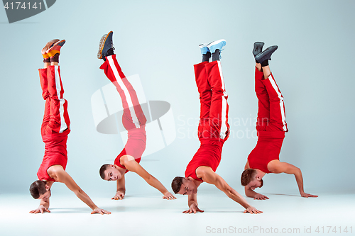 Image of The group of gymnastic acrobatic caucasian men on balance pose