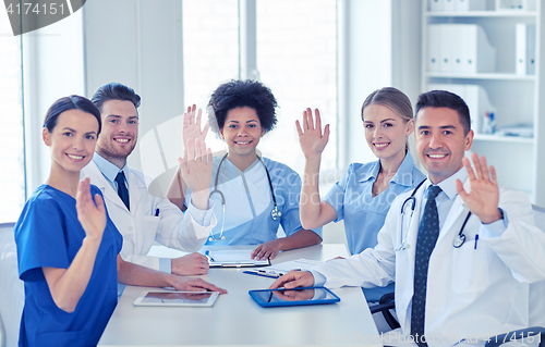 Image of group of happy doctors meeting at hospital office