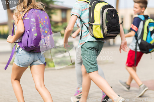 Image of group of happy elementary school students running