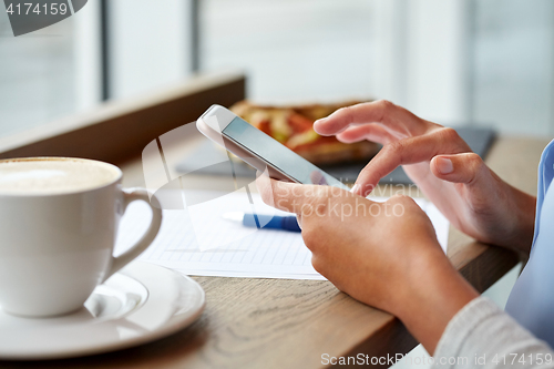 Image of woman with smartphone at cafe