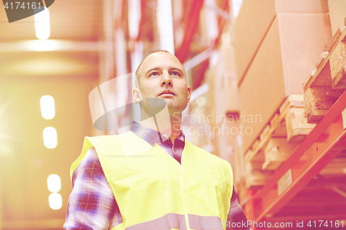 Image of man in reflective safety vest at warehouse