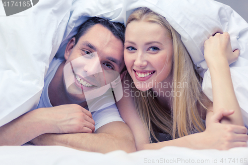 Image of happy couple sleeping in bed