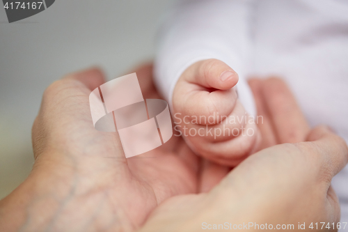 Image of close up of mother and newborn baby hands