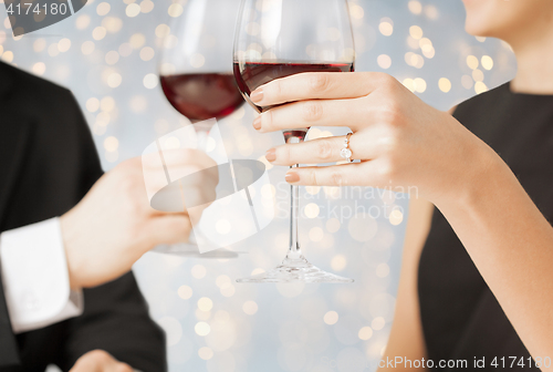 Image of close up of engaged couple with wine glasses