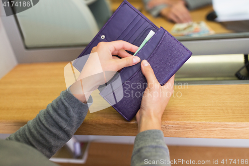 Image of hands with money at bank or currency exchanger