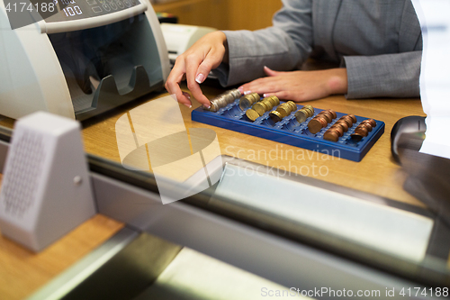 Image of clerk counting cash money at bank office