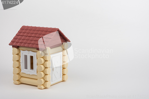 Image of Toy house on a white background, near a place under an inscription