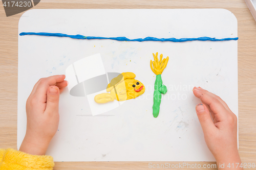 Image of Child blinded pas board for modeling fish and underwater flower in the sea, the top view