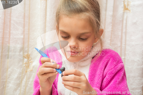 Image of Seven-year girl sculpts from clay crafts, hand-made article makes drawing on the stack