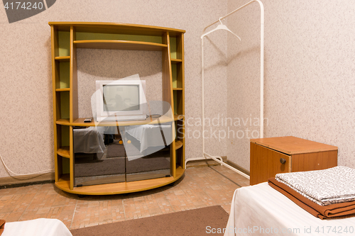 Image of The interior of the small room, the view on the shelf with a TV