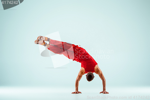 Image of The gymnastic acrobatic caucasian man on balance pose