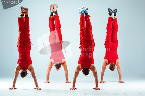 Image of The group of gymnastic acrobatic caucasian men on balance pose