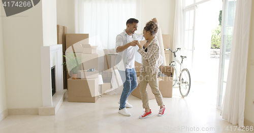 Image of Happy young couple celebrating moving home