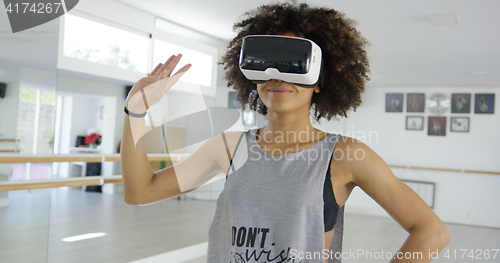 Image of African american girl using VR glasses