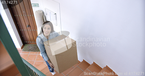 Image of Attractive young woman moving house