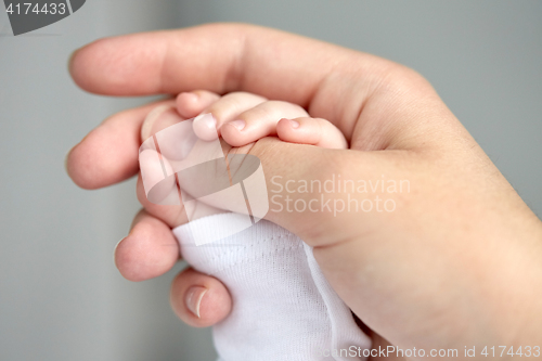 Image of close up of mother and newborn baby hands