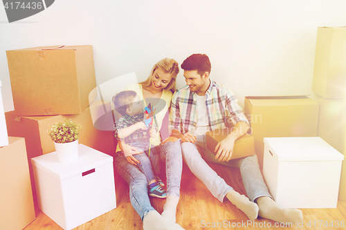 Image of happy family with boxes moving to new home