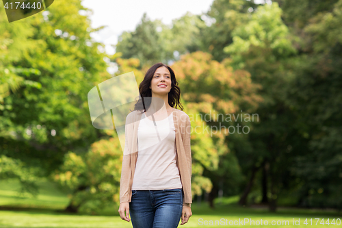Image of beautiful happy young woman in summer park